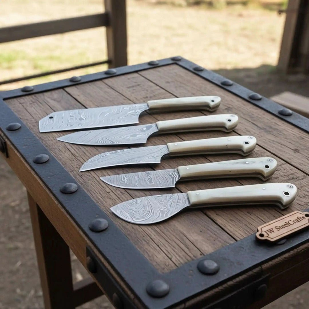 Layered steel chef blades showcased on weathered tabletop with countryside inspired handcrafted workshop aesthetic.