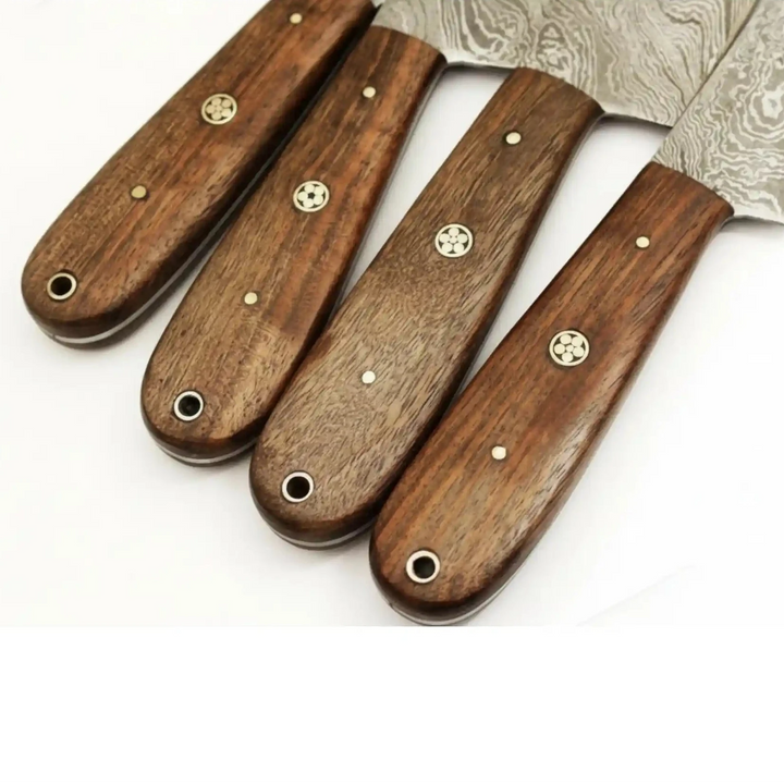 Hardwood Damascus knife handles with decorative brass pins and smooth rounded edges.