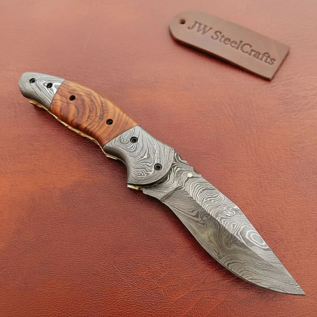     Artisan Damascus folding knife designed for daily carry with ergonomic wooden handle construction