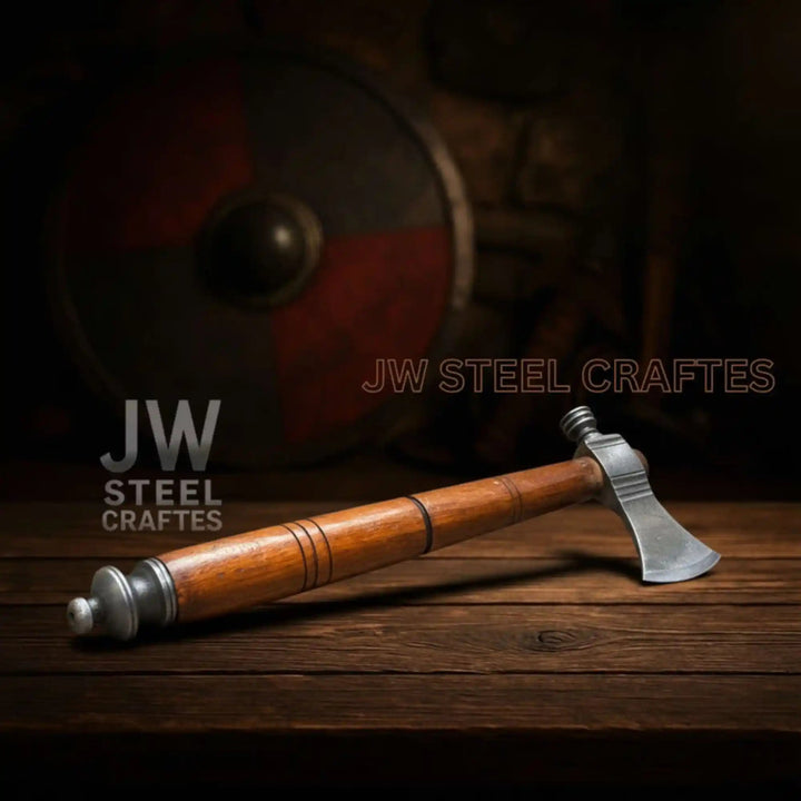 Youthful Damascus camping axe featuring artistic blade layering and curved polished wooden shaft.