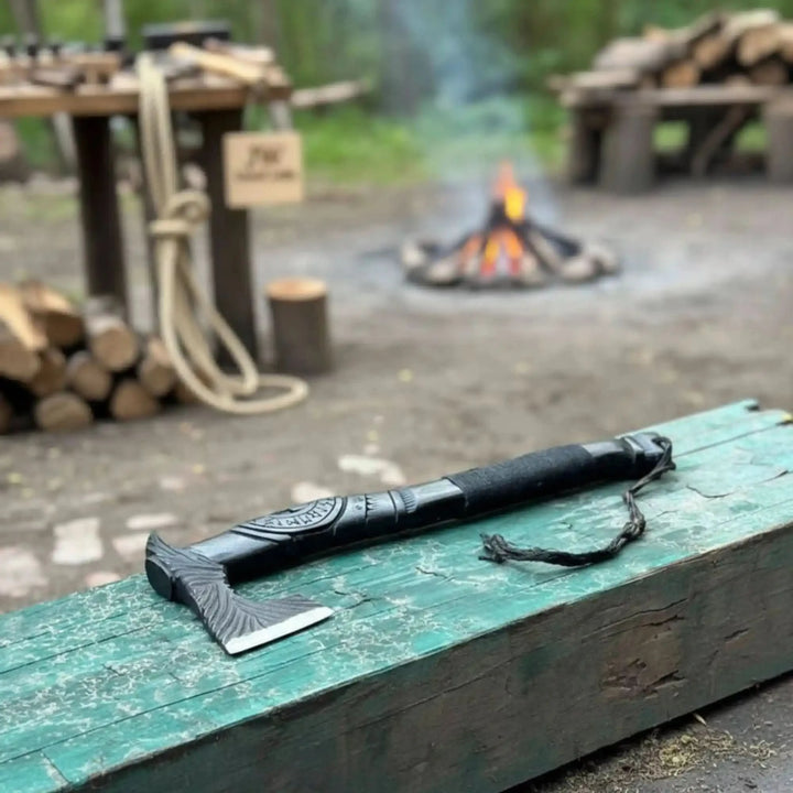 Ashfang-inspired Viking survival tool featuring compact engraved hatchet and rugged outdoor utility styling.