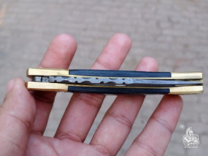 Folding pocket knife with color wood handle.