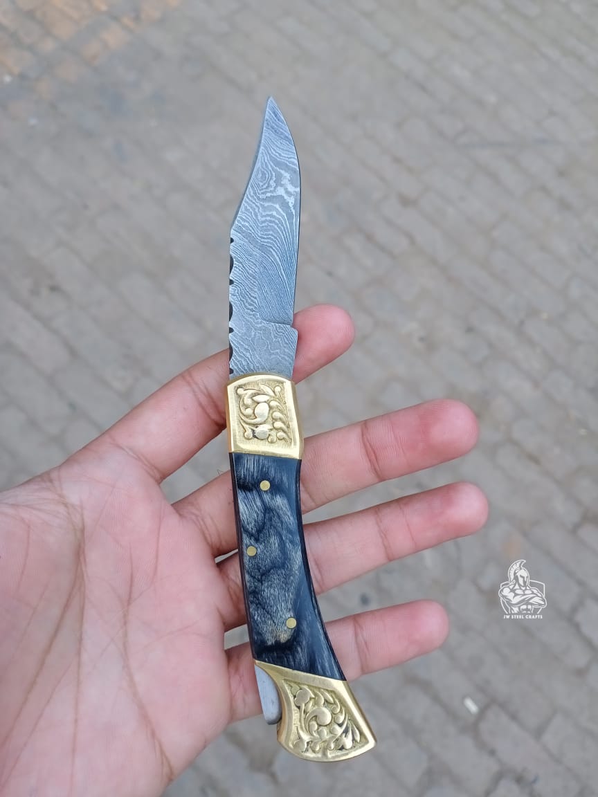 Folding pocket knife with color wood handle.
